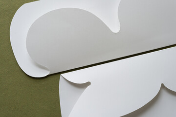 folded paper with decorative cut paper edges on green