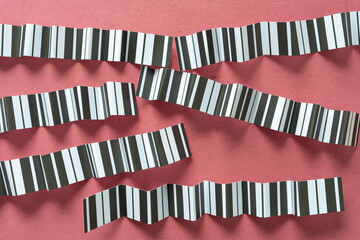 fan folded or creased paper stripes with black and white stripes arranged horizontally or slightly...