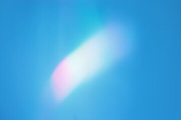 White glare from sunlight in blue background, abstract nature photo with sunshine flare, vivid...