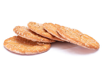 A Heap of Round Salt Crackers with Sesame Isolated on White Background. Dry Snacks - Isolation