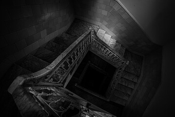 High angle of a spiral staircase in a building in Cienfuegos, Cuba shot in grayscale