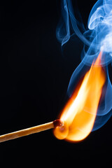 a wooden safety matchstick burning