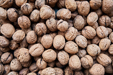 Walnuts with shells (filling the picture). Background of fresh walnuts.