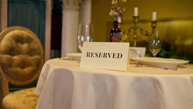 close-up of a reservation sign reserved  standing on a table in an expensive luxury Italian restaurant