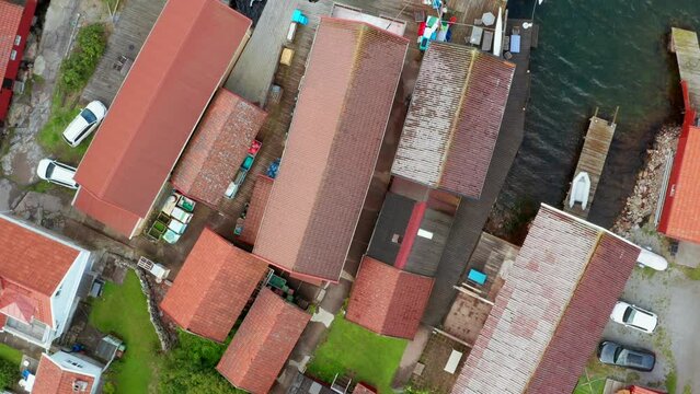 Overhead top down view on small red sheds wooden boat locker houses in Sweden