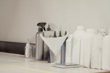 The workplace of the master restorer. Repair of leather goods. Bottles with consumables, paint,...