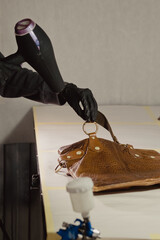 The workplace of the master restorer. Repair of leather goods. Blow-drying of the repair part on a...