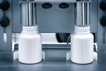 pharmaceutical industry, medicine pills are filling in the  bottle on production line machine...