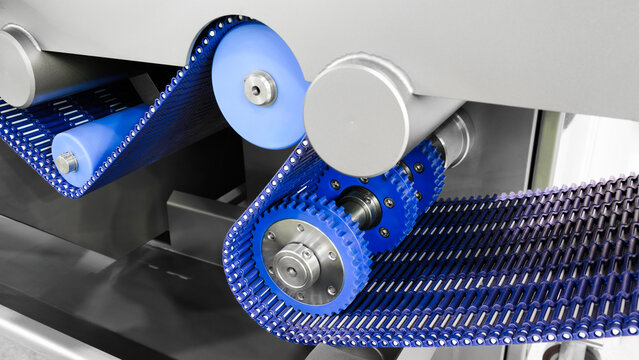 Gear chain drive shaft in conveyor belt is on production line. Timing chain of car, tensioners in engine. Industrial roller chain, technology. Team work, business industrial concept