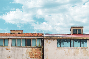 Old worn industrial building with damaged facade