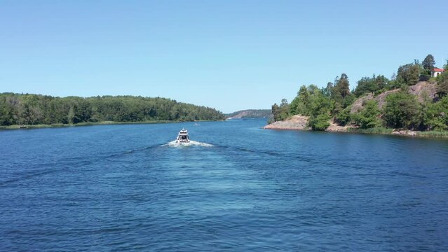 Archipelago Stockholm Sweden Speed motorboat cursing between islands on blue sea