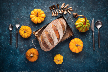 Homemade crusty sourdough bread oven baked made with wheat, activated carbon, pumpkin and curcuma spice and season autumn foods in kitchen
