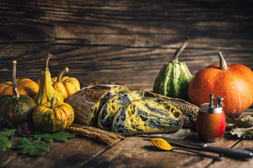 Foto op Canvas Homemade crusty sourdough bread oven baked made with wheat, activated carbon, pumpkin and turmeric spice and season autumn foods in rustic kitchen © ValentinValkov