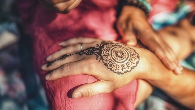 Henna art on woman's hand. Loop Animation.