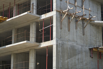 The building of an unfinished high-rise. Work on facade thermal insulation using putty and putty...