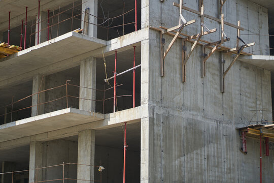 The building of an unfinished high-rise. Work on facade thermal insulation using putty and putty materials during the construction of a high-rise residential building. High quality photo