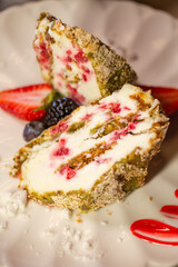 top view of a meringue roll in a section on a white plate close-up