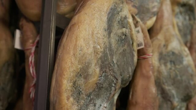 Jamon serrano pig legs factory hanging in a industry. Iberian ham elaboration process