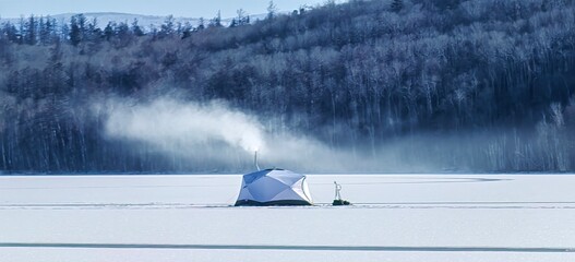 the first ice fishing in a tent on a winter lake in Siberia - obrazy, fototapety, plakaty