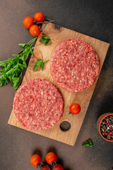 Raw Ground beef meat Burger steak cutlets on a wooden board, Food recipe background. Close up