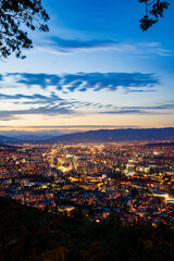 Capturing Mtatsminda Park sunset Tbilisi's Majesty in the Panoramic view Over the Mountains – A Tapestry of Georgia's Capital