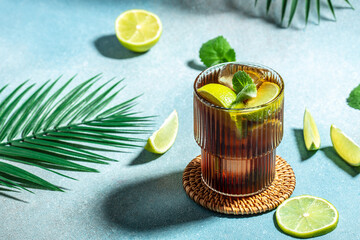 Homemade Cuba Libre with fresh lime, rum, cola, mint in the glass, banner, menu, recipe place for...