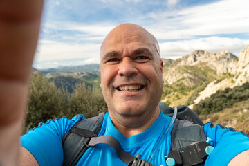  Happy hiker takes a selfie in the mountain.