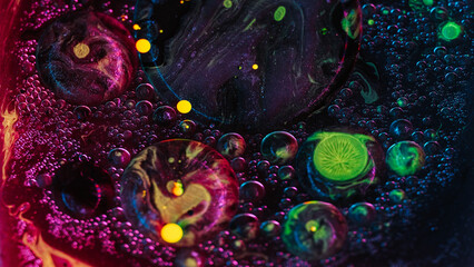 Abstract background. Liquid mix. Colorful acrylic bubbles. Neon glitter texture yellow violet oil ink blob circles motion in stained water art.