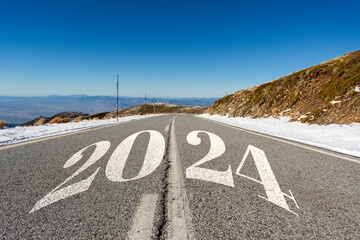 2024 New Year road trip travel and future vision concept . Nature landscape with highway road leading forward to happy new year celebration in the beginning of 2024 for fresh and successful start .