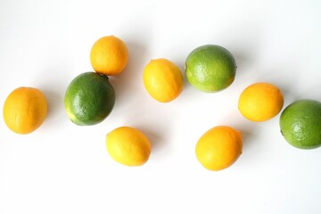 a pile of four limes and three tangerines