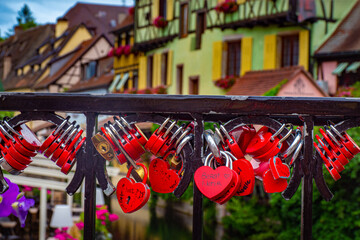 Heart shaped red lovers locks hanging on bridge in Colmar Alsace France