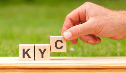 KYC concept of governance and social environment. hand holding wooden cube with letter C