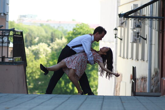 The interracial copule dancing in the city street