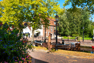 Obraz premium City of Papenburg Germany. Canal, flowers, ship and bridge, Germany