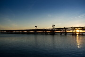 Rio Tinto pier in Huelva, Spain across the scenic Atlantic ocean against the sunset sky