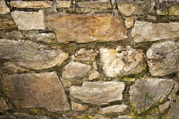 Structural background, masonry of stones of different shapes and structures.