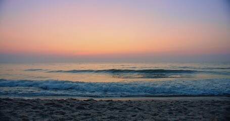 Beautiful amazing sunset over tropical ocean sea beach with pink purple sky and waves breaking on beach in summer Thailand, tourism vacation holiday travel trip destination concept