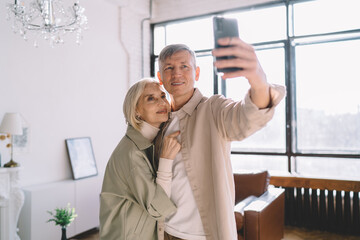 Happy senior couple taking selfie on smartphone