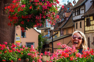 Woman walking through the Beautiful Streets in the village Equisheim Alsace France