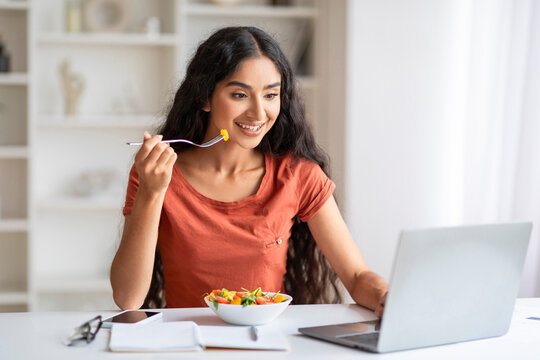 Self-employed young indian woman have lunch at home