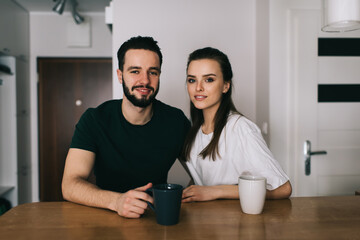 Positive couple resting in modern kitchen