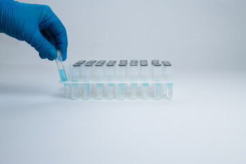 A laboratory medical worker demonstrates test tube for analysis. Test tubes in stand