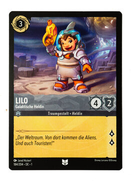 Hamburg, Germany - 10312023: macro photo of the German Ravensburger tradingcard Lilo Galactic Hero from the Disney lorcana The first chapter set on white paper background.