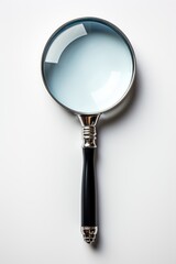 A magnifying glass on a white surface.