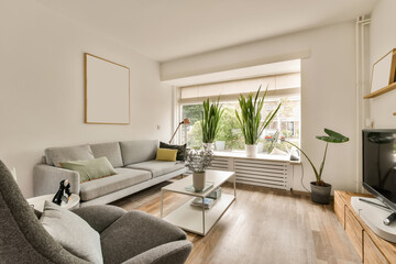Fototapeta premium a living room with two couches and a flat screen tv on the wall in the room is very clean