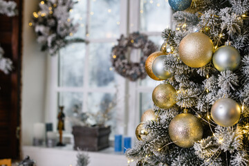 Christmas tree with toys baubles close-up on window background