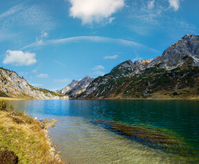 Obraz premium Sunny autumn alpine Tappenkarsee lake and rocky mountains above, Kleinarl, Land Salzburg, Austria.