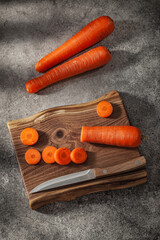 Chopped Carrots On Wooden kitchen Board And knife
