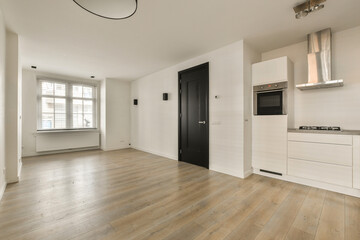 an empty living room with wood flooring and white walls in the room is well lit by the light coming...