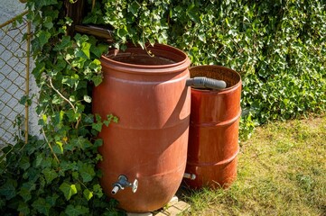 Obraz premium Rainwater tank for rain water harvesting in the garden